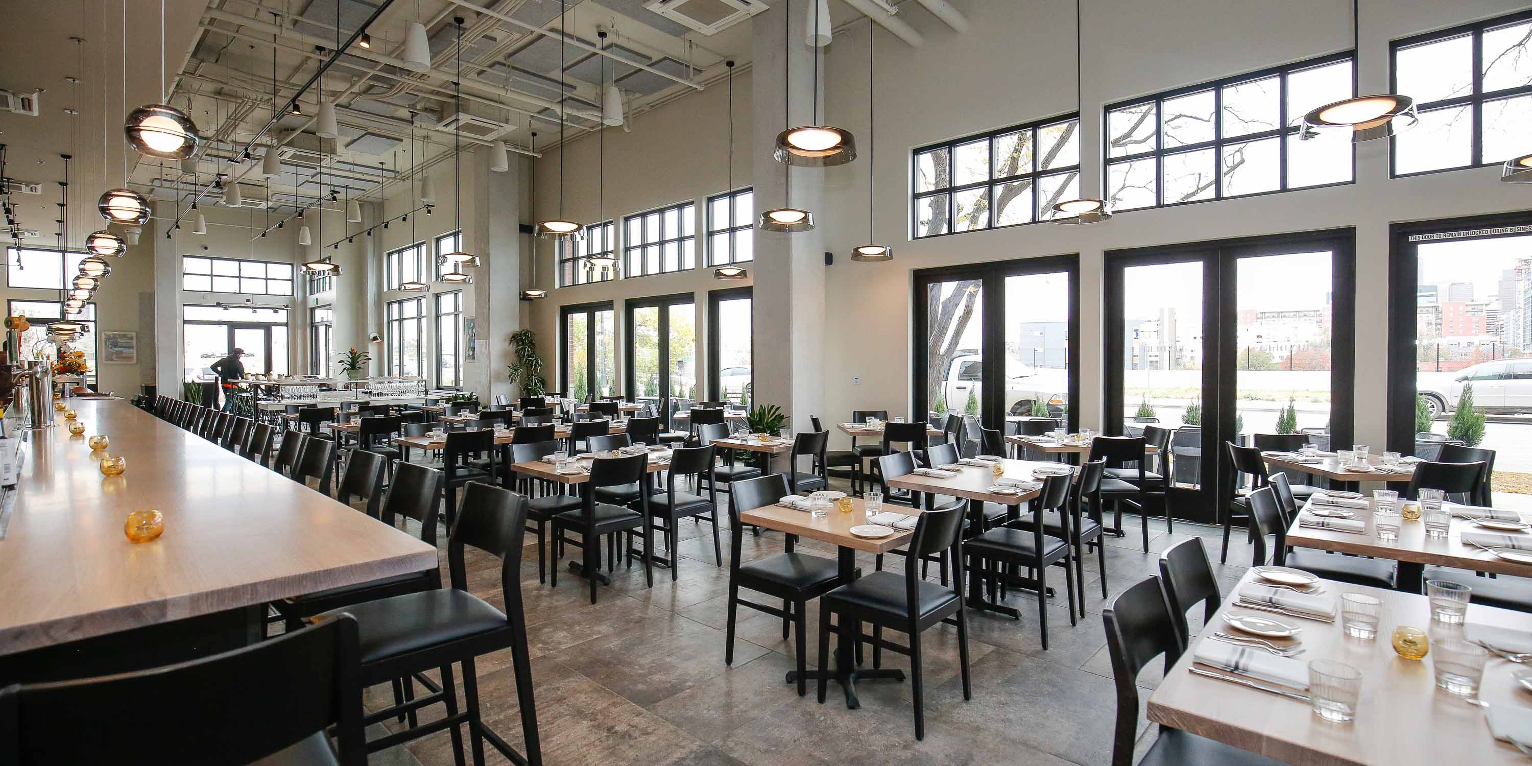 black chairs in an open concept dining hall