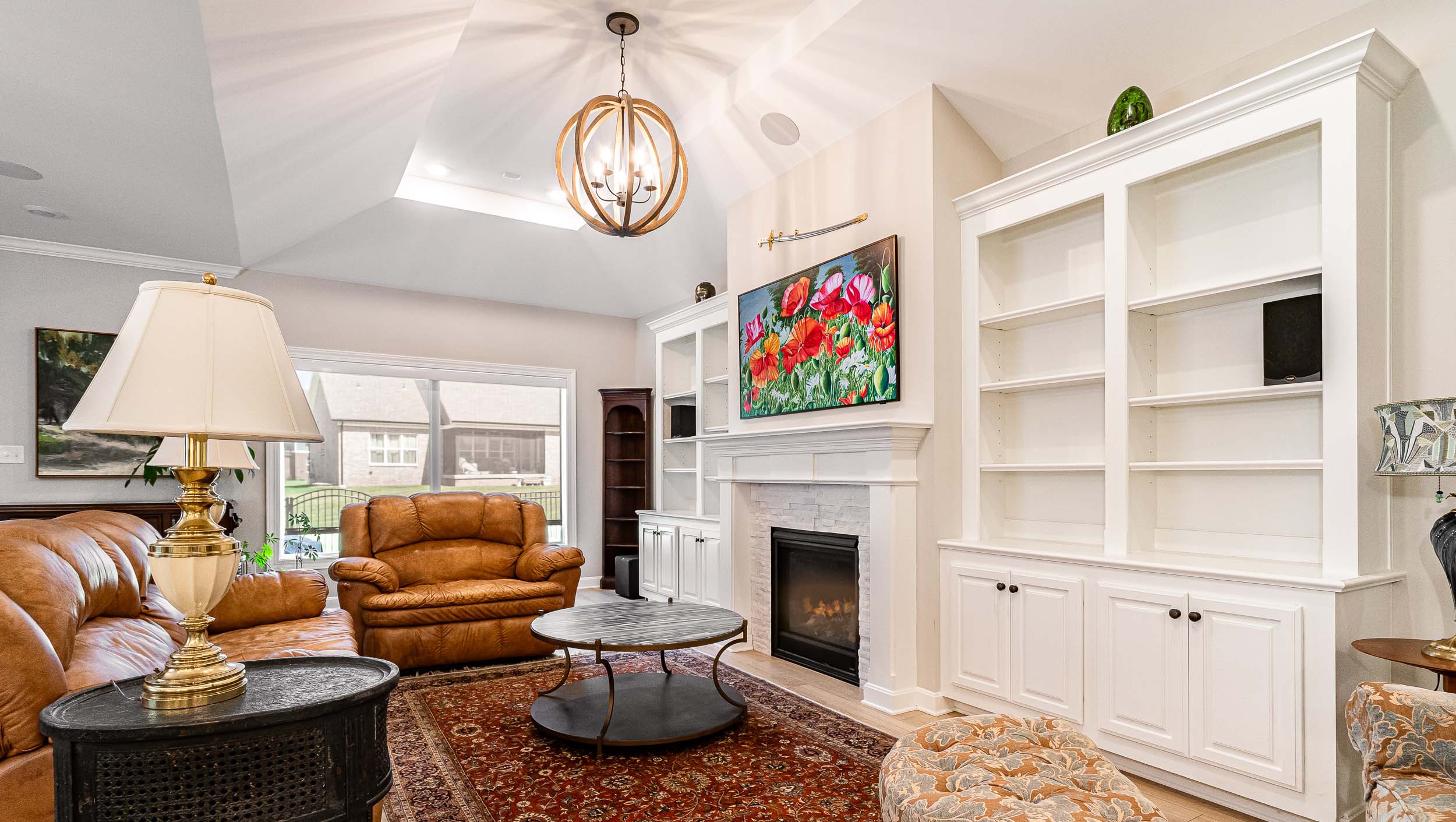 family room with white bookshelves and frame tv