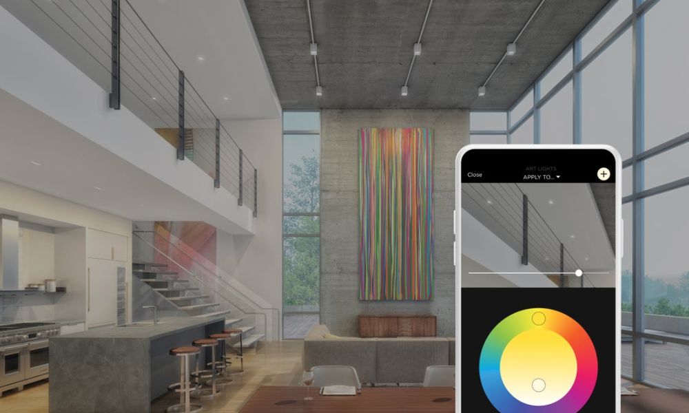 <span class="uk-h4">Savant app color wheel adjusting art lighting in an open-concept loft with kitchen and dining area.</span>