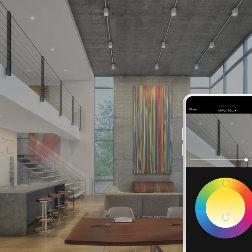 <span class="uk-h4">Savant app color wheel adjusting art lighting in an open-concept loft with kitchen and dining area.</span>