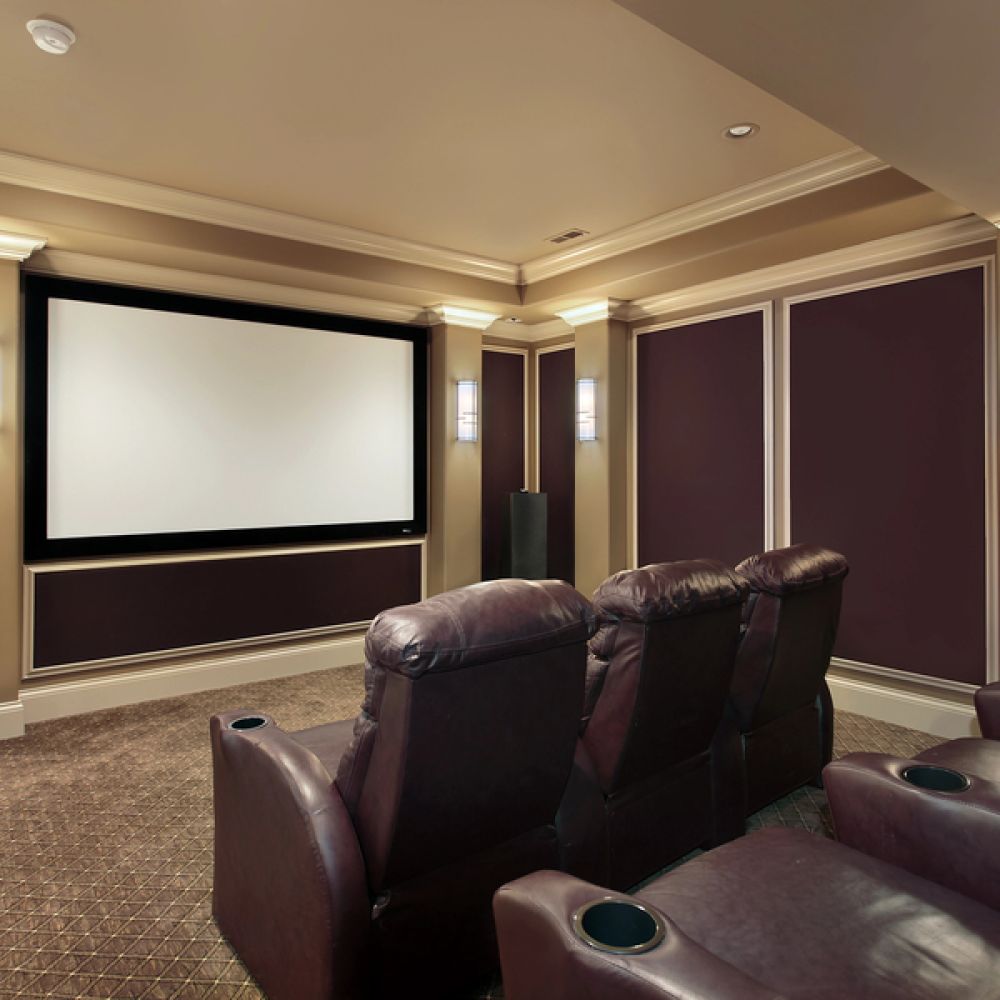 <span class="uk-h4">Home theater room with a large projector screen, leather recliners, and elegant wall sconces.</span>