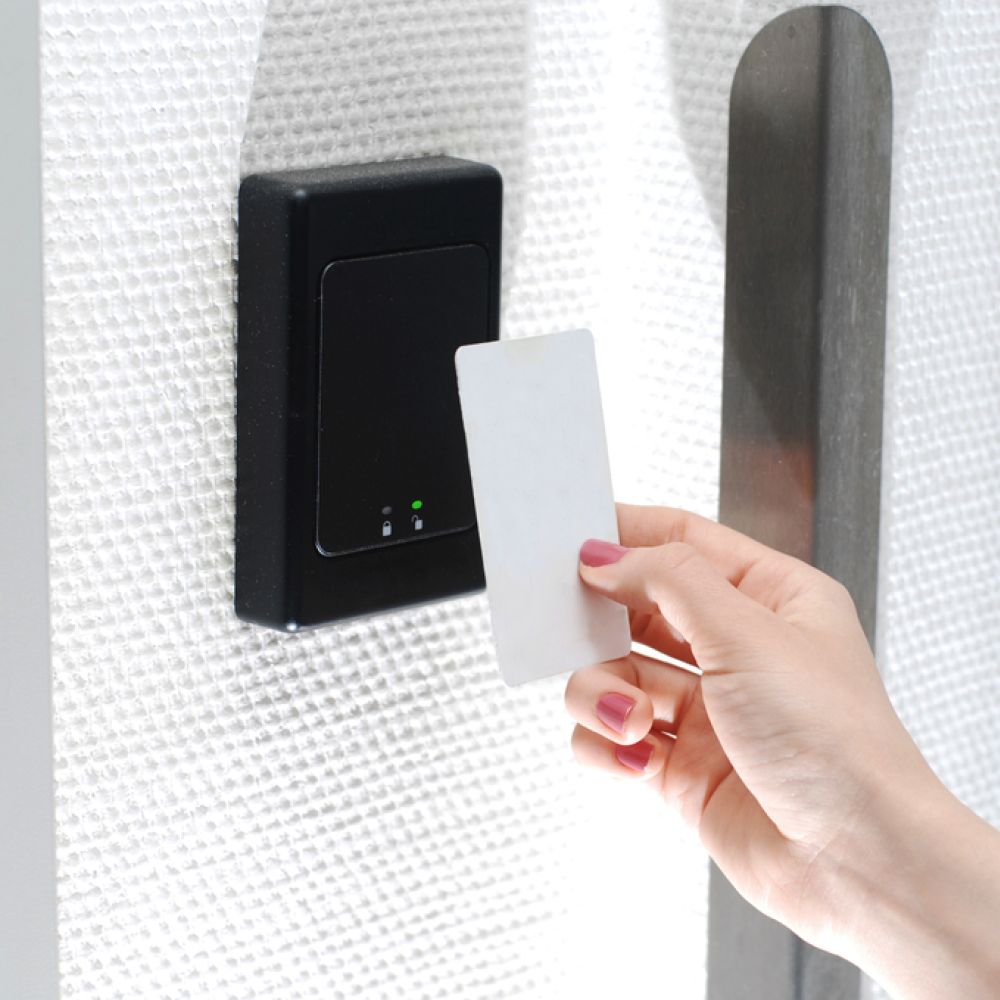 <span class="uk-h4">A hand uses a magnetic card to gain access to a door through a card reader.</span>