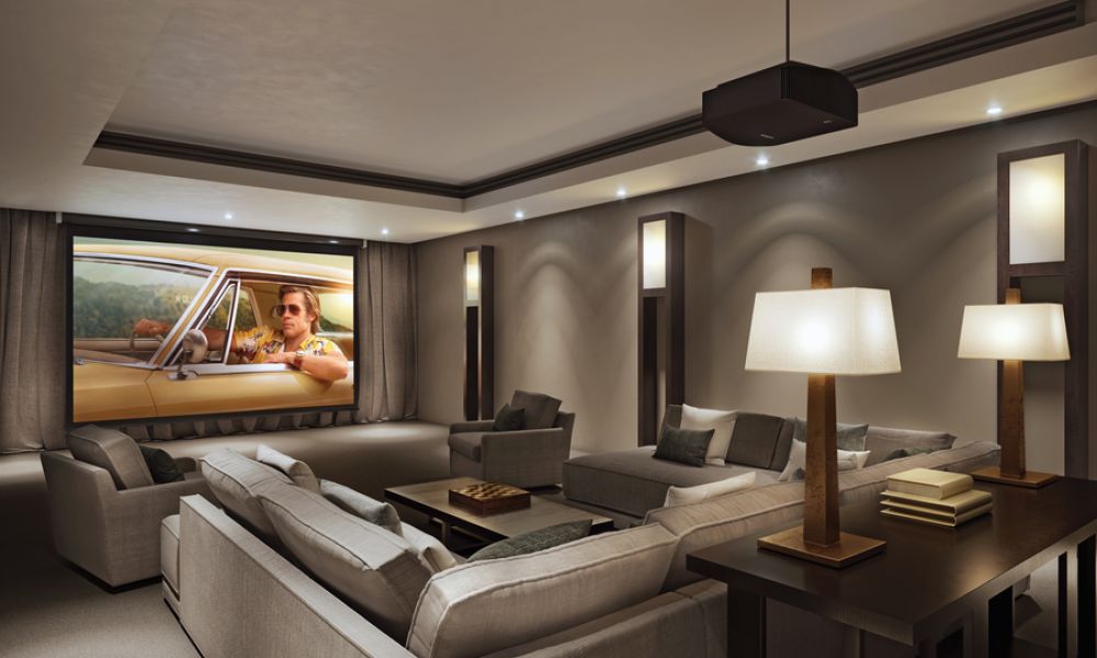 <span class="uk-h4">A luxury media room with a large screen, hidden audio, and expansive sofa seating.</span>