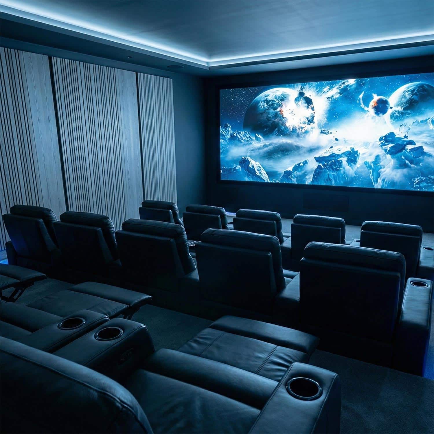 Dark home theater with blue accent lighting and space imagery on screen