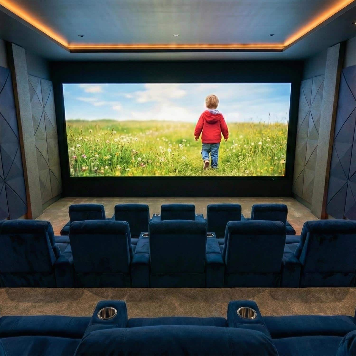 Luxury screening room with tiered blue velvet seating and geometric walls